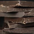 A close-up of a stack of dark chocolate
