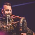 man playing leather bag pipes