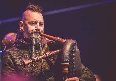 man playing leather bag pipes